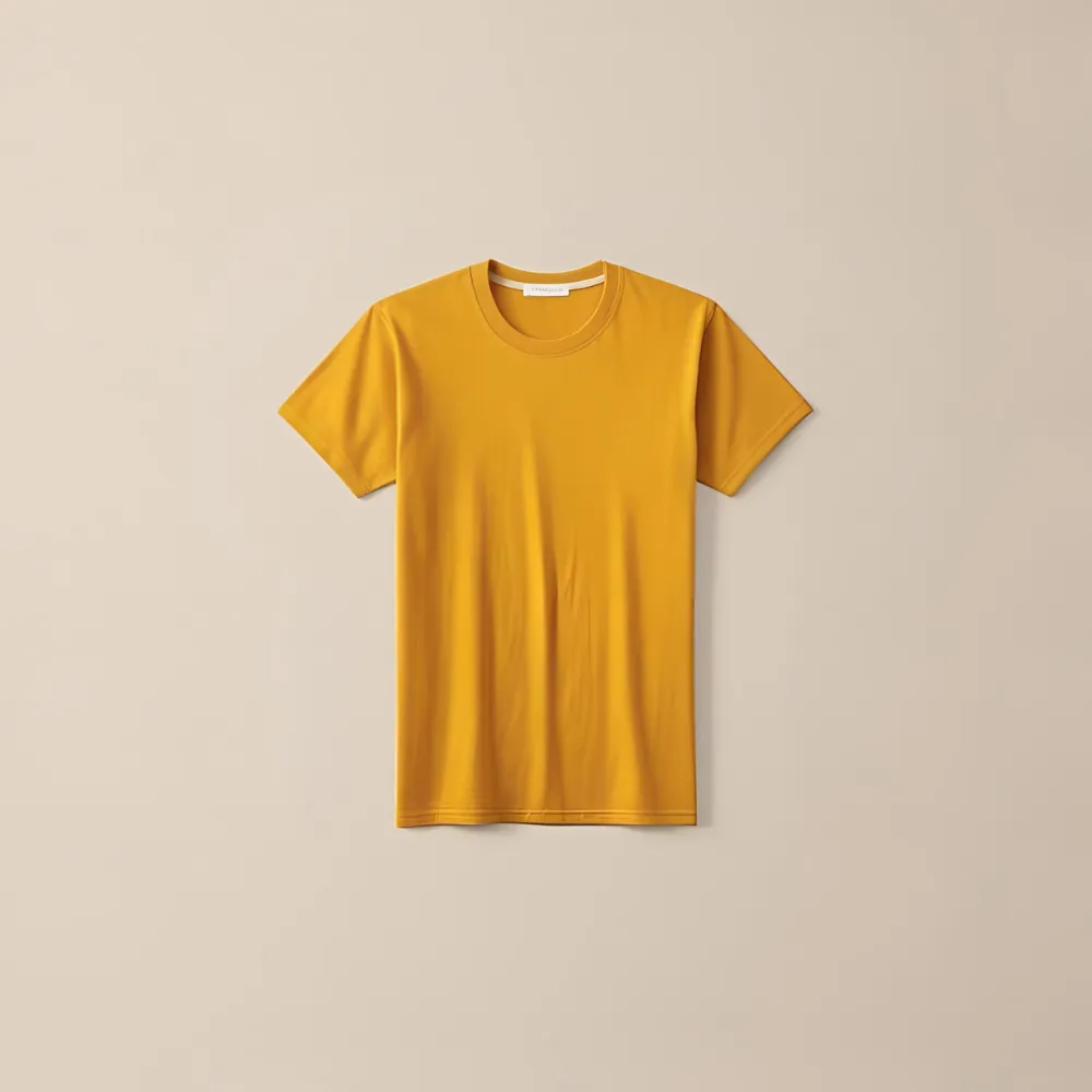 A mustard yellow cotton t-shirt photographed in a studio setting against a two-toned background.