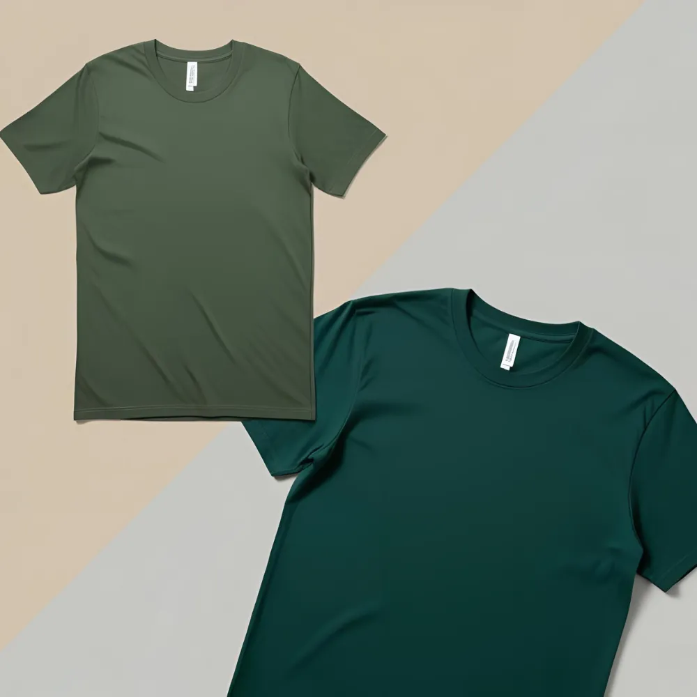 Two cotton t-shirts in different shades of green (forest and olive) laid out on a mixed background.